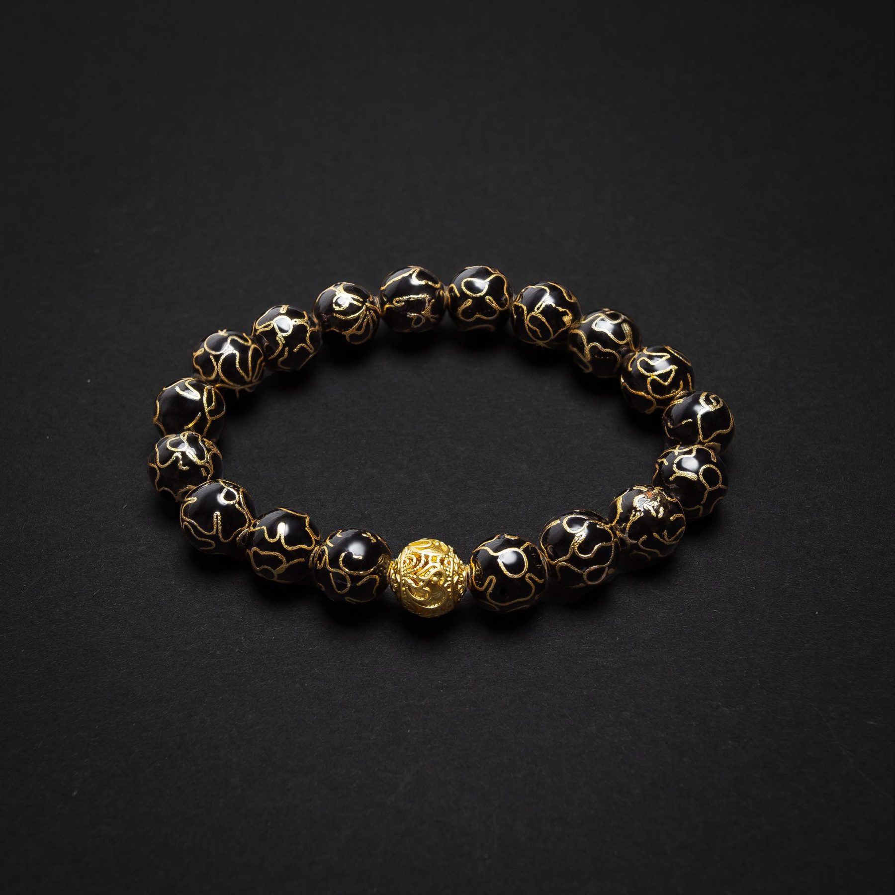 Midnight Cloisonné bracelet – A sophisticated black enamel bangle with gold accents, reflecting timeless luxury and celestial beauty.